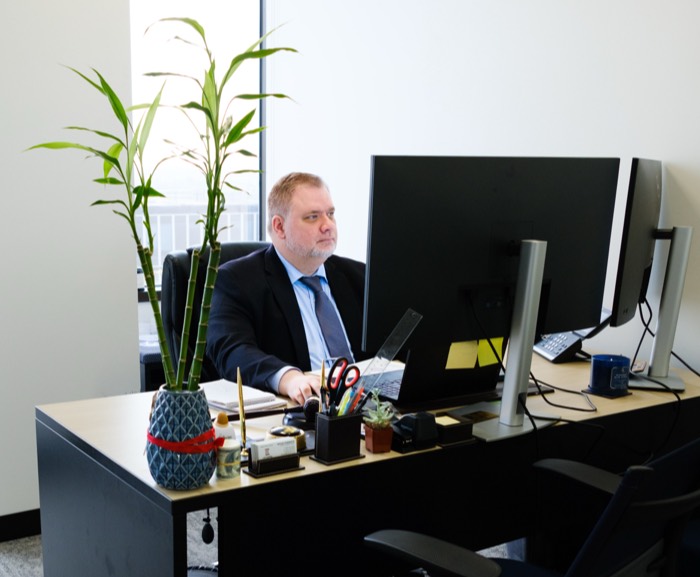 business professional at his desk working on computer