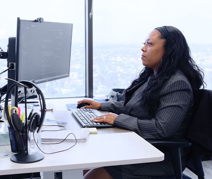 CAP_Candid_professional woman at desk Riverside