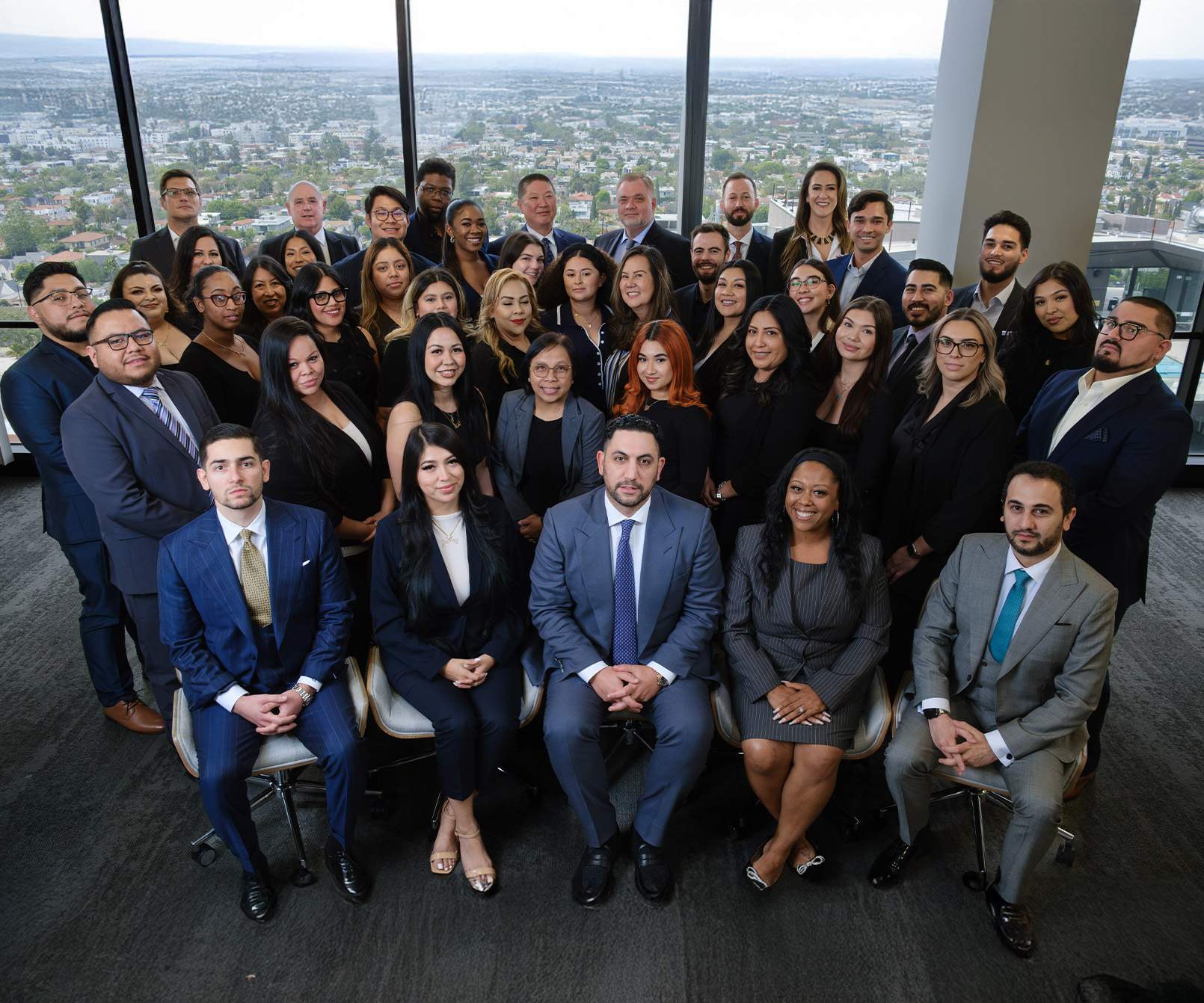 group portrait of CAPFIRM team in front of office window