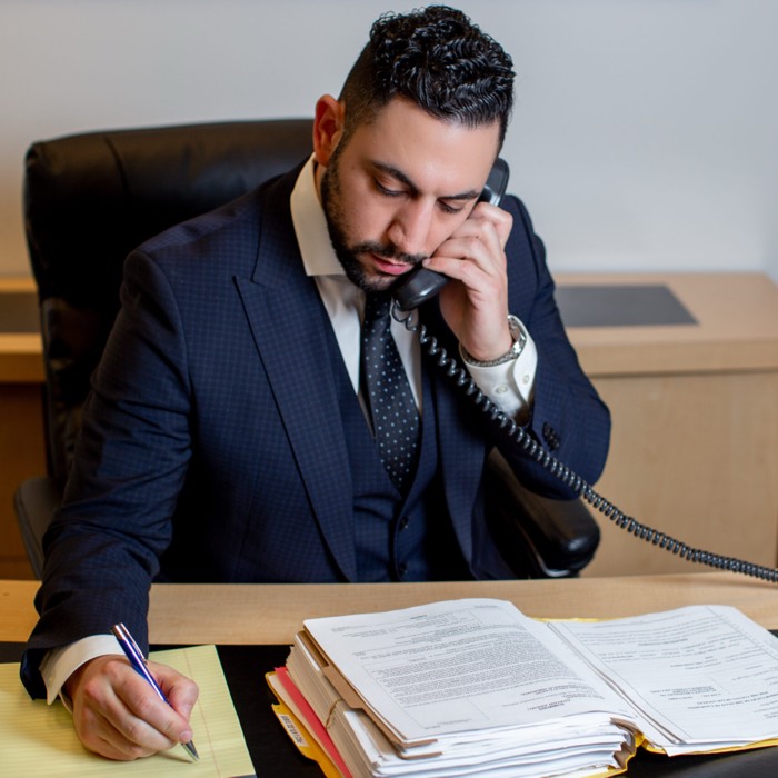 informal portrait of Joshua Zokaeem working at his desk